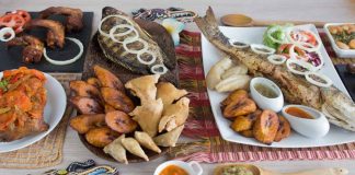 Kamerun, Afrika’nın en zengin mutfak kültürlerinden birine sahiptir. Ülkenin coğrafi yapısı, tropikal iklimi ve çok sayıda etnik grubun bir arada yaşaması, Kamerun mutfağı için son derece geniş bir çeşitlilik sunar. Farklı bölgelerde yaşayan toplulukların yemek alışkanlıkları birbirinden farklıdır. Bu farklılıklar, ülkenin kuzeyinden güneyine, batısından doğusuna kadar sofralara yansıyan çok renkli bir gastronomi tablosu ortaya çıkarır. Baharatların bolca kullanılması, taze sebze ve kök bitkilerin yemeklerde sıkça yer alması Kamerun sofralarının karakteristik özelliklerinden biridir. Konulu bir haber görseli.