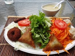 Reunion Mutfağı, Hint Okyanusu’nda yer alan Reunion Adası’nın zengin kültürel mirasını sofralara taşır. Ada mutfağı, Fransız, Afrika, Hint ve Çin etkilerini bir araya getirerek kendine özgü bir tat profili oluşturur. Bu kültürel çeşitlilik, yemeklerde hem renk hem de aromatik derinlik sağlar. Konulu bir haber görseli.