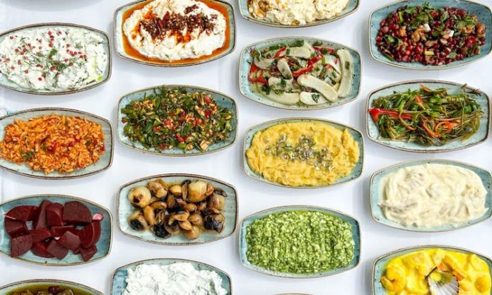 Sofraların Ortak Dili Olarak Meze Kültürü ve Toplumsal Hafızadaki Yeri Meze kültürü, yalnızca yemek öncesi iştah açan küçük tabaklardan ibaret olmayan, tarihsel, kültürel ve sosyolojik boyutları olan güçlü bir sofracılık geleneğini temsil eder. Anadolu’dan Akdeniz’e, Balkanlar’dan Orta Doğu’ya uzanan geniş bir coğrafyada meze kültürü, birlikte yeme, paylaşma ve sohbet etme pratiğinin merkezinde yer alır. Bu yönüyle meze, sadece damak tadına değil, toplumsal ilişkilere de hitap eden bir kültür unsurudur. Konulu bir haber görseli.